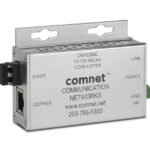 Ein silberner Medienkonverter der Marke Comnet mit Anschlüssen für Fiber und Copper sowie Angaben zur Stromversorgung.