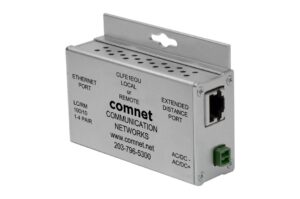 Ein silbernes elektronisches Gerät mit der Aufschrift "comnet COMMUNICATION NETWORKS", das über Ethernet- und erweiterte Distanzanschlüsse verfügt. Es scheint ein Netzwerkgerät zu sein.