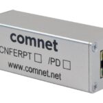 Ein rechteckiges, silbernes Netzwerkgerät von Comnet mit der Aufschrift "CNFERPT /PD" und einer Ethernet-Anschlussbuchse.