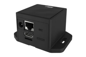 Ein schwarzer elektronischer Würfel mit HDMI- und Netzanschluss sowie einer Strombuchse auf der Vorderseite.