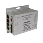 Ein silberner Ethernet-Switch von ComNet mit mehreren Anschlüssen.