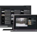 Ein Monitor und ein Laptop zeigen eine Sicherheitssoftware-Oberfläche mit Videoüberwachungsaufnahmen.