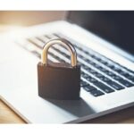 Lock on laptop as computer protection and cyber safety concept. Private data protection from hacker malware