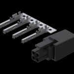 Ein schwarzer elektrischer Steckverbinder mit vier Anschlussöffnungen neben einer Anordnung von fünf silbernen metallischen Anschlussstiften auf einem schwarzen Hintergrund.