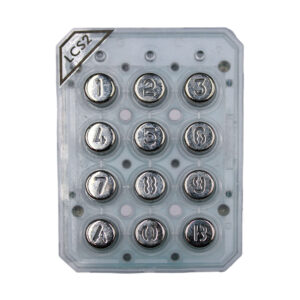 Metallische Tastatur mit zwölf kreisförmigen Drucktasten in einem rechteckigen Gehäuse, mit den Ziffern 1 bis 9 und drei Symbolen; oberhalb ist "LCS2" vermerkt.