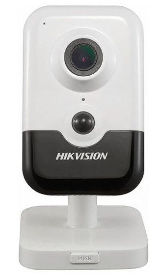 Eine weiße Überwachungskamera von Hikvision mit einem schwarzen Sockel und integrierter Linse, montiert auf einem weißen Standfuß.