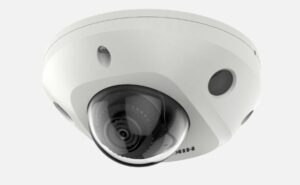 Dome-Kamera mit weißem Gehäuse und einem dunklen, transparenten Schutzglas, das die Linse umgibt.
