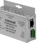 Metallisches Netzwerkgerät mit mehreren Anschlüssen und dem Logo von "comnet Communication Networks".