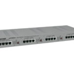 Graues Netzwerkgerät mit mehreren Ethernet-Ports und sichtbarem Text "comnet" und "ETHERNET PORTS".