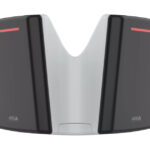 Ein modernes, schwarzes und weißes Gerät mit leuchtenden roten Linien auf einer glatten Oberfläche.