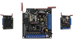 Eine elektronische Schaltung mit mehreren Anschlüssen und bauteilen, zentral ein großer Chip, umgeben von kleineren Elementen.