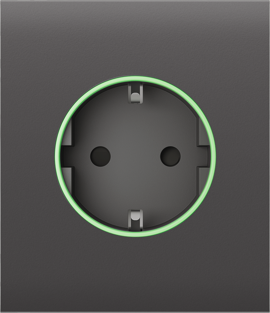 Steckdose mit schwarzem Rahmen und grünem Leuchtring auf dunklem Hintergrund.