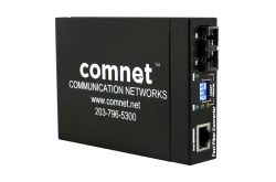 Ein schwarzer Netzwerk-Konverter von Comnet mit Anschlüssen und einer Beschriftung "Communication Networks" sowie einer Website- und Telefonnummer-Angabe.