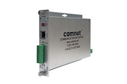 Ein silbernes Kommunikationsgerät mit der Aufschrift "comnet Communication Networks" und mehreren Anschlüssen an der Seite.