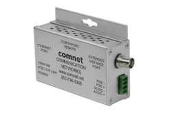 Ein silberner Ethernet-Extender von ComNet mit verschiedenen Anschlüssen und Ports, einschließlich eines Ethernet-Ports und eines erweiterten Distanzports.