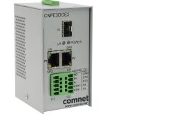 Netzwerkgerät von Comnet mit mehreren Anschlüssen und Schaltflächen auf einer Metalloberfläche.