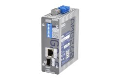 Ein graues AMG260-Gerät mit zwei Ethernet-Anschlüssen und blauen DIP-Schaltern auf der Oberseite, vor einem weißen Hintergrund.