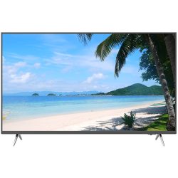 Fernseher mit einer Bildschirmaufnahme eines Strandes mit Palmen, weißem Sand und klarem, blauem Meer unter einem blauen Himmel.
